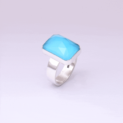 Handmade sterling silver ring with doublet made of natural crystal quartz and turquoise gemstones in a parallelogram shape. The doublet consists of two layers of stones. The upper stone is faceted crystal quartz and the stone at the bottom is turquoise. Buy online shop.