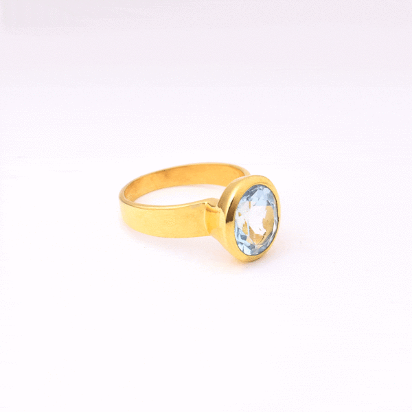 Handmade oval shaped ring made of natural blue topaz stone and gold plated silver 925.