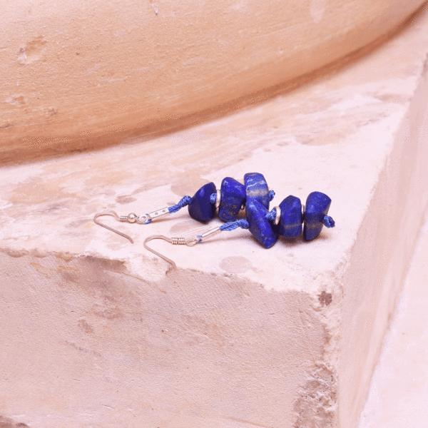 Handmade long earrings made of natural, irregular shaped lapis lazuli gemstones and sterling silver.