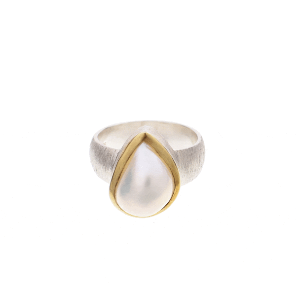Handmade ring made of sterling silver and natural, teardrop shaped pearl. The ring has textured band and gold plated bezel. 