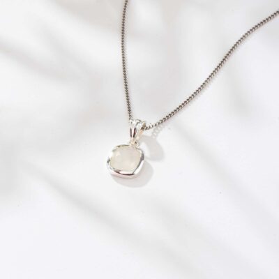 Handmade pendant made of sterling silver and natural, square shaped white labradorite gemstone. The pendant is threaded on a sterling silver chain.