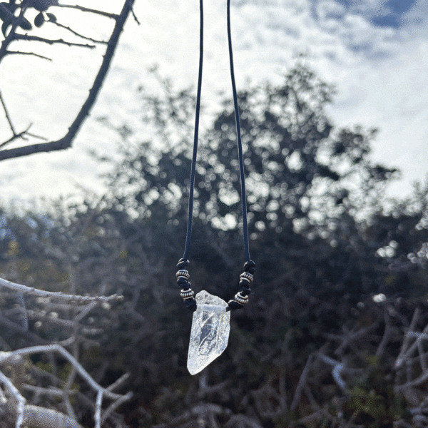 Handmade necklace featuring a natural, crystal quartz gemstone, measuring 59cm in length, threaded on a black leather with sterling silver details.
