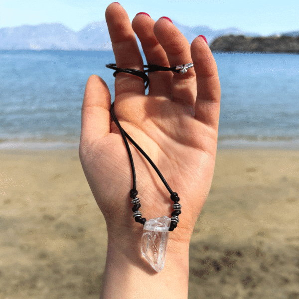 Handmade necklace featuring a natural, crystal quartz gemstone, measuring 59cm in length, threaded on a black leather with sterling silver details.