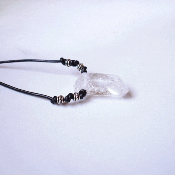 Handmade necklace featuring a natural, crystal quartz gemstone, measuring 59cm in length, threaded on a black leather with sterling silver details.