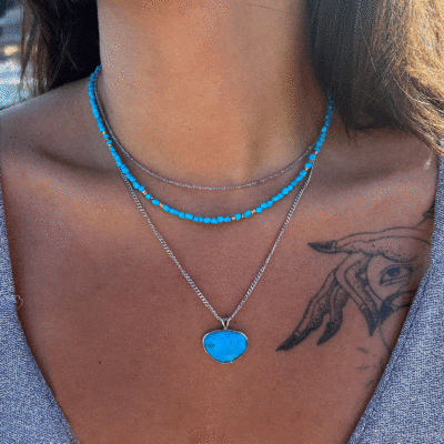 Handmade sterling silver pendant featuring a natural, irregular-shaped Turquoise stone, threaded on a fine silver chain.