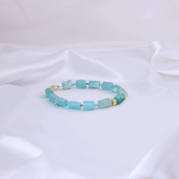 Handmade bracelet made of natural, raw amazonite stones in cylindrical shape, decorated with natural pyrite, amazonite and gold-plated sterling silver details.