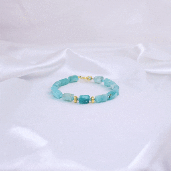 Handmade bracelet made of natural, raw amazonite stones in cylindrical shape, decorated with natural pyrite, amazonite and gold-plated sterling silver details.