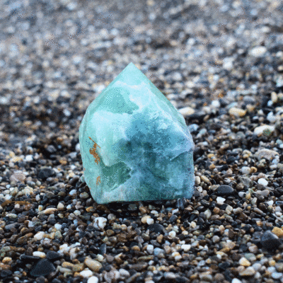 Natural green Fluorite gemstone in a point shape, with a flat cut base and a height of 8cm approximately. This piece features raw sides and a polished point. 