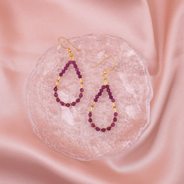 Handmade earrings made of natural, spherical, faceted ruby stones and small gold-plated hematite grommets. The necklace features gold-plated sterling silver elements and clasp, adding luxury and sparkle, creating a piece of jewellery that exudes femininity and power.