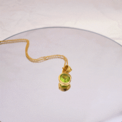 Handmade necklace made of natural Peridot stone in an oval shape and gold-plated sterling silver. The length of the chain is adjustable and it ranges from 40cm (minimum) until 45cm (maximum).