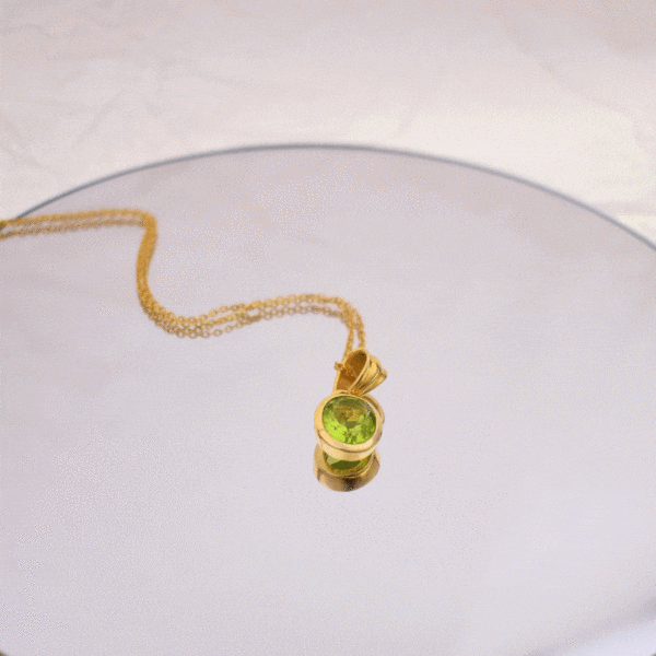 Handmade necklace made of natural Peridot stone in an oval shape and gold-plated sterling silver. The length of the chain is adjustable and it ranges from 40cm (minimum) until 45cm (maximum).