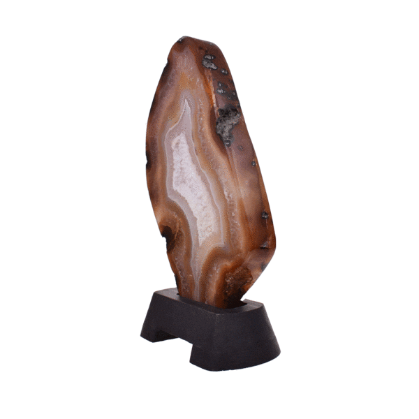 Polished slice of natural agate gemstone with crystal quartz, in warm earthy tones. Mounted on a black wooden base, this elegant piece stands 22cm tall.