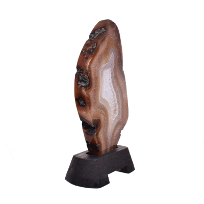 Polished slice of natural agate gemstone with crystal quartz, in warm earthy tones. Mounted on a black wooden base, this elegant piece stands 22cm tall.