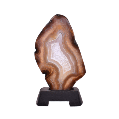 Polished slice of natural agate gemstone with crystal quartz, in warm earthy tones. Mounted on a black wooden base, this elegant piece stands 22cm tall.