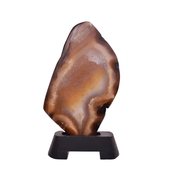 Polished slice of natural agate gemstone with crystal quartz, in warm earthy tones. Mounted on a black wooden base, this elegant piece stands 22cm tall.